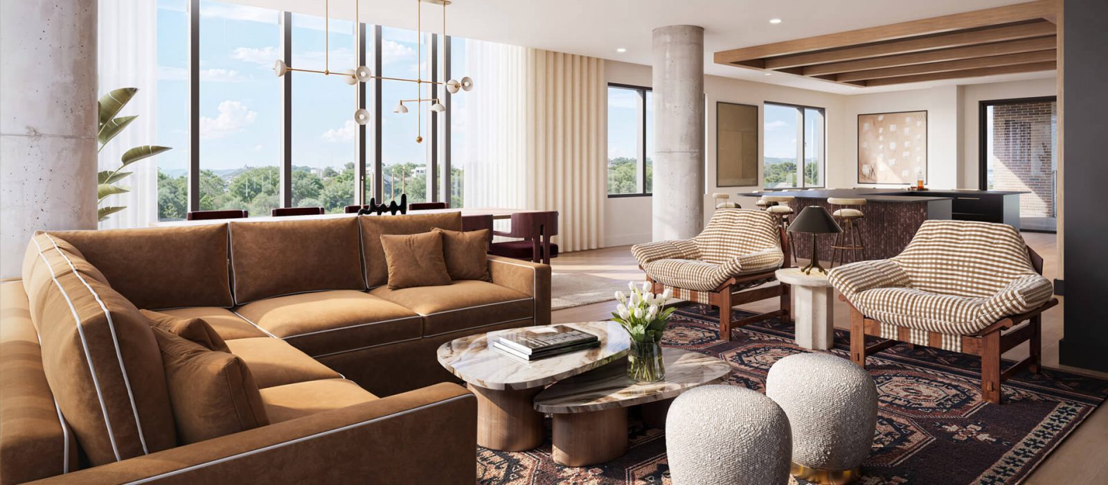 Spacious living room with brown leather seating, patterned rug, modern coffee tables, and large windows showcasing panoramic views of the surrounding area.
